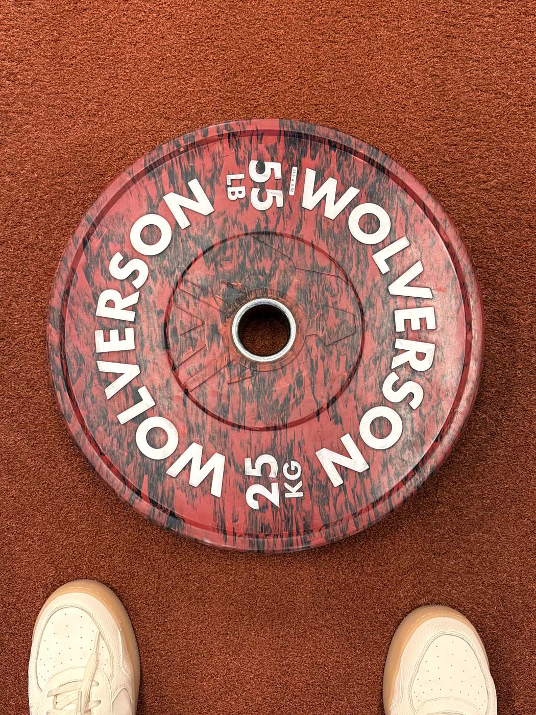Weight plate and training shoes — personal training studio detail