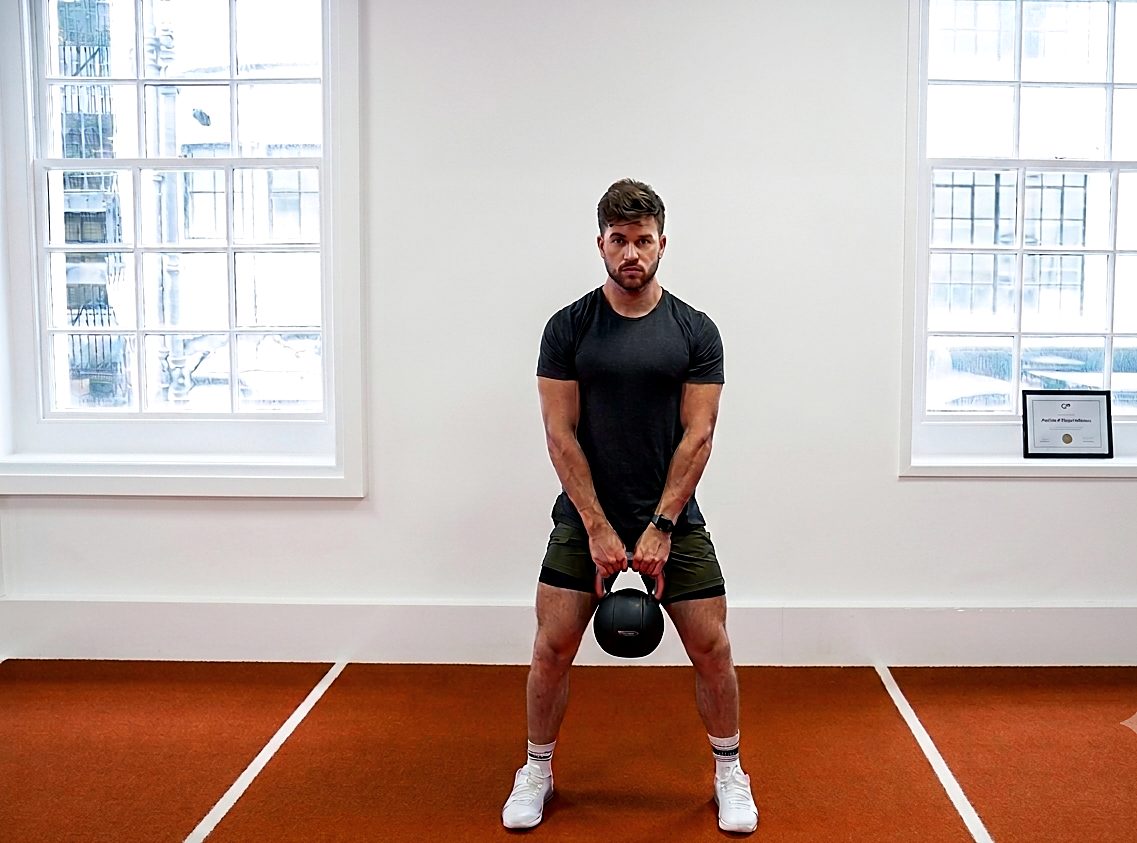 Olly Banks performing a kettlebell goblet squat in a Marylebone studio